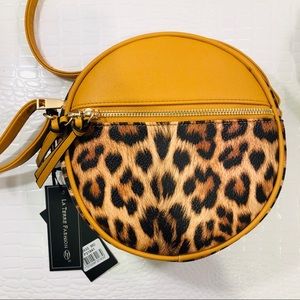 Vegan leather purse with adjustable strap.